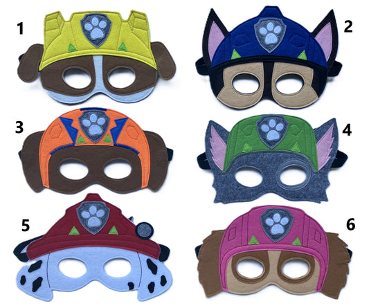 Six felt paw patrol themed masks  numbered 1 through 6, each with a different color scheme and Paw Patrol-inspired emblem, displayed on a white background. Each mask contains lots of details to best represent the character in the new show 