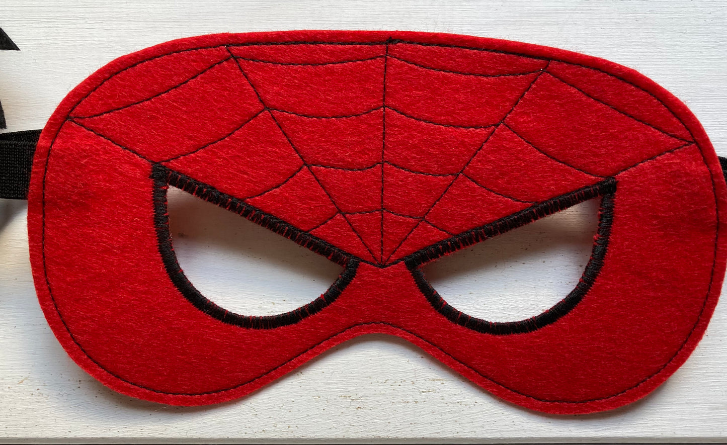 handmade felt spider man mask, Red mask with spider web design on a white background