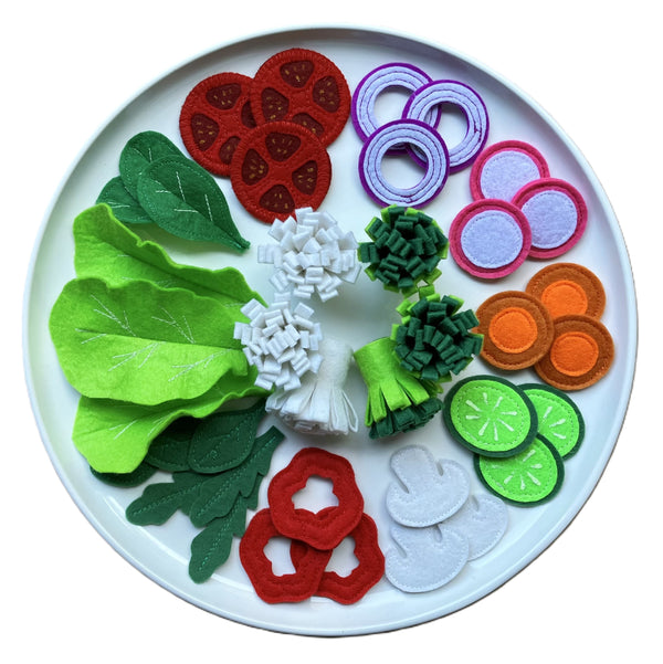 handmade felt food set with Cauliflower Broccoli Bell pepper Tomato Turnip Carrot Cucumber Onion Ring Mushroom Lettuce Baby spinach Rucola (rocket) and Basil presented on a white plat