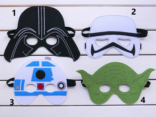 Four Star Wars-themed masks on a wooden surface