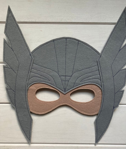 thor Gray superhero mask with brown accents on a light wooden background