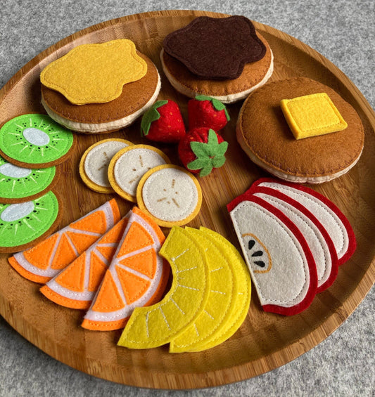 Handmade felt pancakes including fruits and various spread presented on a bambuu plate